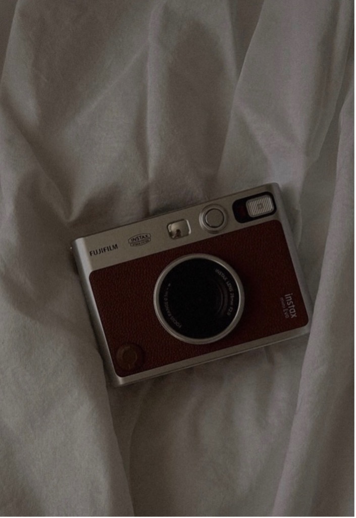 A lifestyle product photo being taken with a phone, showing hands setting up the scene, authentic and relatable style, black and white.