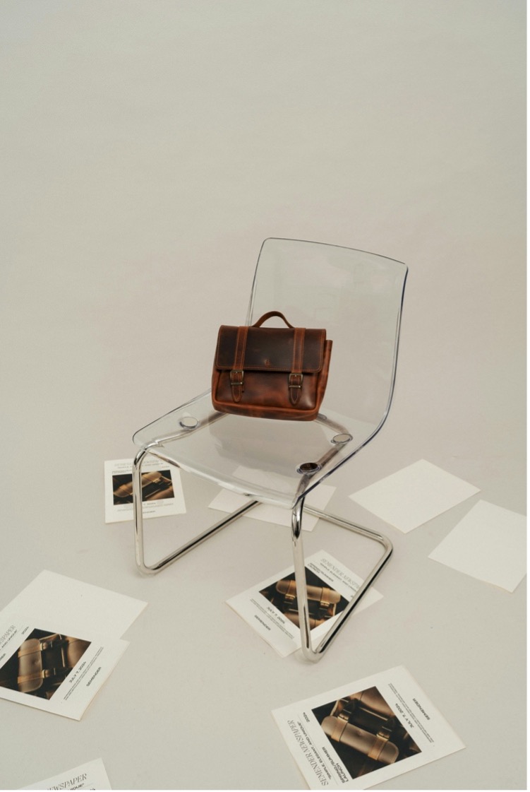 Behind the scenes of a professional video shoot in a studio, camera on a tripod, softbox lighting, cinematic black and white.